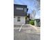 Modern building exterior with parking space #124, gray paneling, and greenery, showcasing contemporary design and outdoor space at 3195 Blake St # 106, Denver, CO 80205