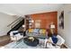 Stylish living room with a wood-paneled accent wall, modern furniture, and a staircase at 3195 Blake St # 106, Denver, CO 80205
