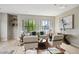 Sunlit living room boasts hardwood floors, large windows, stylish furniture, and artistic decor creating an inviting space at 3195 Blake St # 106, Denver, CO 80205