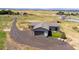Aerial view of house, landscaping, and a large driveway at 8408 Vinegarroon Rd, Parker, CO 80138
