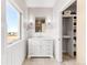 Modern bathroom with white vanity and linen closet at 8408 Vinegarroon Rd, Parker, CO 80138