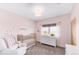 Bright Bedroom featuring a crib, dresser, and window views at 8408 Vinegarroon Rd, Parker, CO 80138