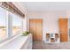 Bedroom with large window, built-in changing table, and closet at 8408 Vinegarroon Rd, Parker, CO 80138