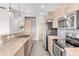 Modern kitchen with stainless steel appliances and light wood cabinets at 8408 Vinegarroon Rd, Parker, CO 80138