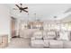 Spacious living room with large windows and a beige couch at 8408 Vinegarroon Rd, Parker, CO 80138