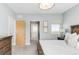 Bright bedroom with king-size bed and access to a bathroom at 8408 Vinegarroon Rd, Parker, CO 80138