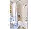 A bathroom featuring a shower/tub with a shower curtain and white subway tiles at 1811 S Quebec Way # 103, Denver, CO 80231