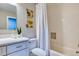 Bright bathroom with a white vanity, neutral paint, and a shower with a curtain at 1811 S Quebec Way # 103, Denver, CO 80231