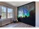 Bedroom features a window and artistic closet doors at 1811 S Quebec Way # 103, Denver, CO 80231