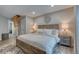 Spacious bedroom featuring a cozy king bed, side tables, and an attic access ladder at 1811 S Quebec Way # 103, Denver, CO 80231