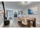 Bright dining area with a stone fireplace, sliding glass doors, and modern light fixture at 1811 S Quebec Way # 103, Denver, CO 80231