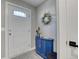 Cozy entryway features a blue cabinet with wreath, adding charm to the home at 1811 S Quebec Way # 103, Denver, CO 80231