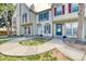 Townhome exterior featuring unique design details, a well-maintained yard, and inviting entrance at 1811 S Quebec Way # 103, Denver, CO 80231