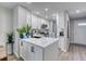 Well-lit kitchen with white cabinets, stainless appliances, and an island with a black faucet at 1811 S Quebec Way # 103, Denver, CO 80231