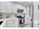 Kitchen with stainless steel appliances, white cabinets, and a white subway tile backsplash at 1811 S Quebec Way # 103, Denver, CO 80231