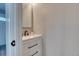 Chic powder room featuring modern vanity, black hardware, and neutral decor at 1811 S Quebec Way # 103, Denver, CO 80231