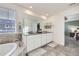 Bathroom with double sinks, granite countertops, tile floors, soaking tub, and large bright window at 14147 Hudson St, Thornton, CO 80602