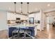 Kitchen with a large center island, pendant lighting, barstool seating and stainless steel appliances at 14147 Hudson St, Thornton, CO 80602