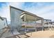 Exterior view showing the home's backyard with a covered patio and stair access to the yard at 5960 S Platte Canyon Dr, Littleton, CO 80123