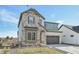Charming two-story home featuring stone accents, a two-car garage, and well-manicured front yard at 5960 S Platte Canyon Dr, Littleton, CO 80123