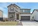Beautiful two-story home featuring stone accents, a two-car garage, and a well-maintained front yard at 5960 S Platte Canyon Dr, Littleton, CO 80123