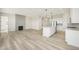Spacious open-concept living room and kitchen with wood floors, fireplace, and large center island at 5960 S Platte Canyon Dr, Littleton, CO 80123