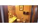 Half bathroom featuring a single sink vanity and decorative wallpaper at 12592 E Cornell Cir, Aurora, CO 80014