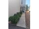 Townhome entrance featuring manicured shrubbery, a walkway to the door, and a secure storm door for added peace of mind at 12592 E Cornell Cir, Aurora, CO 80014