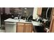 Kitchen featuring stainless steel appliances, oak cabinets, and ample counter space at 12592 E Cornell Cir, Aurora, CO 80014