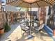 Private brick patio with dining area, a shade umbrella, and a view of the lush surroundings, great for entertaining at 12592 E Cornell Cir, Aurora, CO 80014