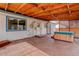 Cozy back porch featuring a hot tub, wood beams, and a lattice wall at 1056 S Macon Way, Aurora, CO 80012