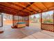 Cozy back porch featuring a hot tub, wood beams, and a lattice wall at 1056 S Macon Way, Aurora, CO 80012