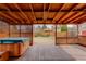 Cozy back porch featuring a hot tub, wood lattice and exposed beams at 1056 S Macon Way, Aurora, CO 80012