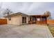 Spacious backyard featuring a large concrete patio and a charming covered wood deck perfect for outdoor gatherings at 1056 S Macon Way, Aurora, CO 80012