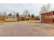 This backyard showcases a patio cover, a garden shed, and a gravel area ready for outdoor enjoyment and storage at 1056 S Macon Way, Aurora, CO 80012