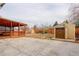 Large backyard featuring a wooden patio cover, storage shed and large concrete slab for low maintenance at 1056 S Macon Way, Aurora, CO 80012