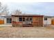 The backyard presents a charming covered patio, perfect for relaxing, adjacent to a lush lawn at 1056 S Macon Way, Aurora, CO 80012