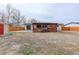 The backyard features a covered wood patio and spacious yard, perfect for outdoor entertainment and relaxation at 1056 S Macon Way, Aurora, CO 80012