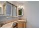 Bathroom with double vanity, tile countertops, and vintage lighting at 1056 S Macon Way, Aurora, CO 80012