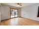 Bright bedroom with hardwood floors and sliding glass door leading to the backyard at 1056 S Macon Way, Aurora, CO 80012