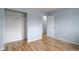 This bedroom offers natural light, hardwood floors, neutral paint, and a spacious closet perfect for storage at 1056 S Macon Way, Aurora, CO 80012