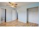 Bedroom with bathroom and closet entrances featuring hardwood floors at 1056 S Macon Way, Aurora, CO 80012