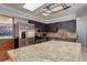 Bright kitchen featuring stainless steel appliances, a pot rack, granite countertops, and tile backsplash at 1056 S Macon Way, Aurora, CO 80012