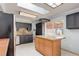 Bright kitchen featuring granite counters, tile floors, stainless appliances and a pot rack at 1056 S Macon Way, Aurora, CO 80012