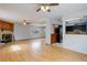 Open concept living room featuring hardwood floors, a fireplace, open bar to the kitchen, and lots of natural light at 1056 S Macon Way, Aurora, CO 80012