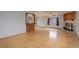 Open concept living room featuring gleaming hardwood floors, a cozy fireplace, and an open bar to the kitchen at 1056 S Macon Way, Aurora, CO 80012