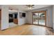 Bright living room featuring hardwood floors, a ceiling fan, and sliding glass doors to the outside patio at 1056 S Macon Way, Aurora, CO 80012