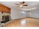 Bright living room featuring gleaming hardwood floors, a cozy fireplace, and a flood of natural light at 1056 S Macon Way, Aurora, CO 80012
