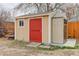 Backyard shed featuring painted wood and a contrasting bright red door plus a plastic storage shed at 1056 S Macon Way, Aurora, CO 80012