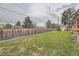 Spacious backyard with a lush lawn, privacy fence, and mature trees at 8102 S Carr Ct, Littleton, CO 80128